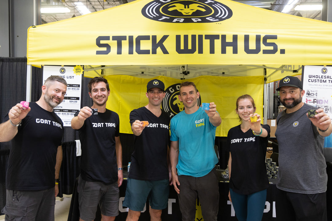 Goat Tape team at event booth holding tape rolls