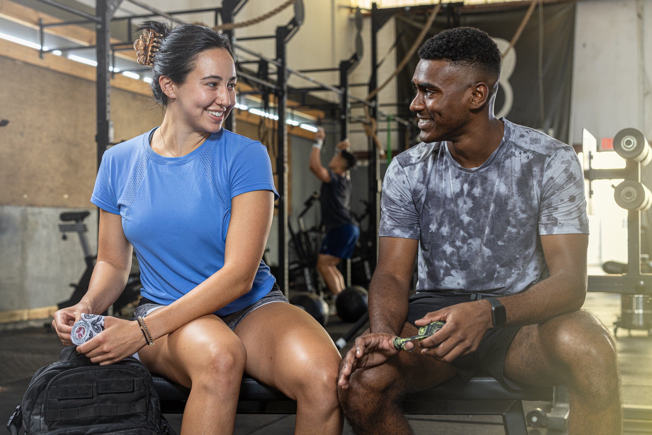 Athletes sitting in gym usingGoat Tape rolls