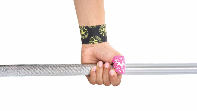 Hand gripping bar with Goat Tape on wrist and thumb