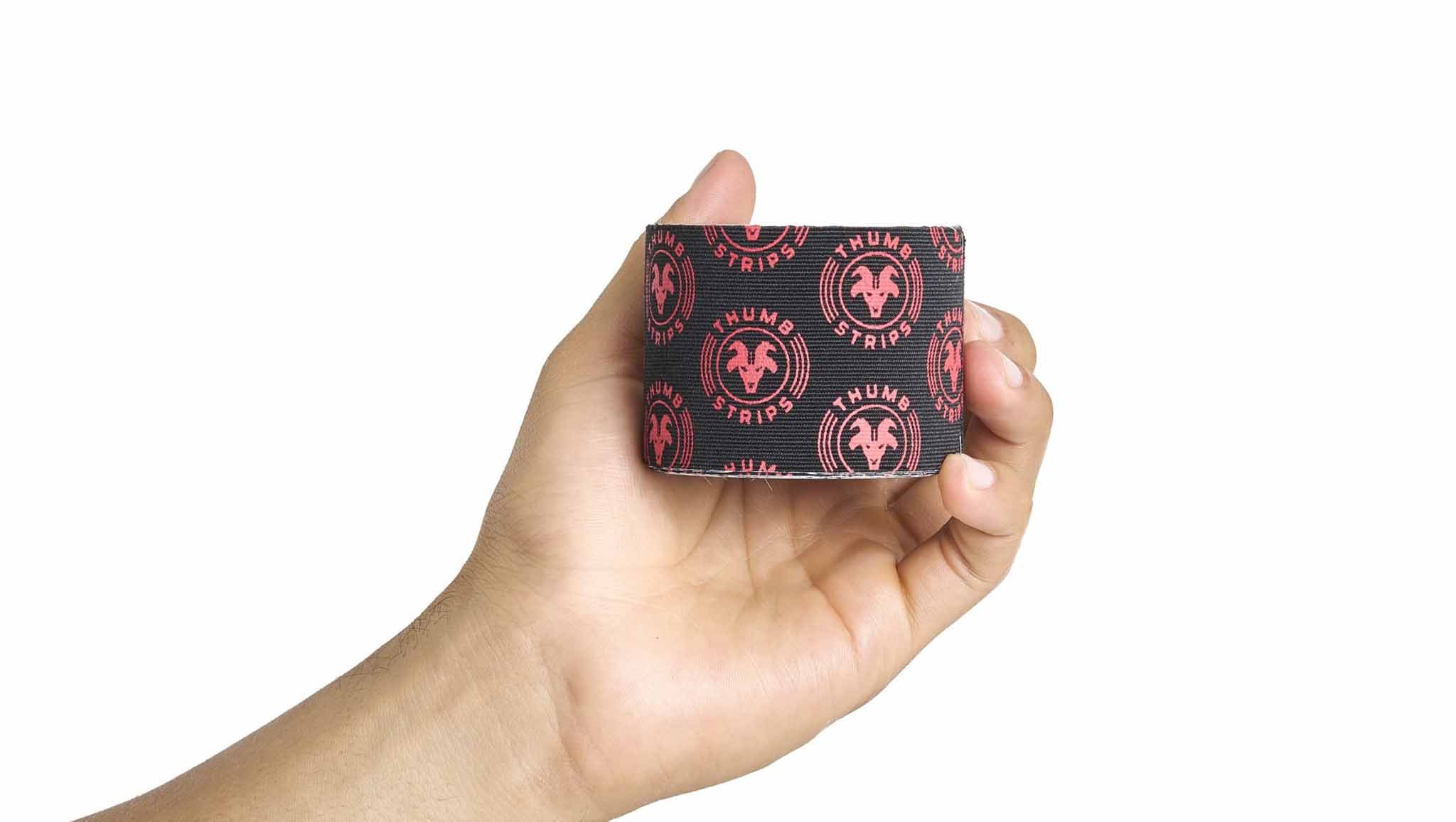 Hand holding a roll of thumb tape strips 