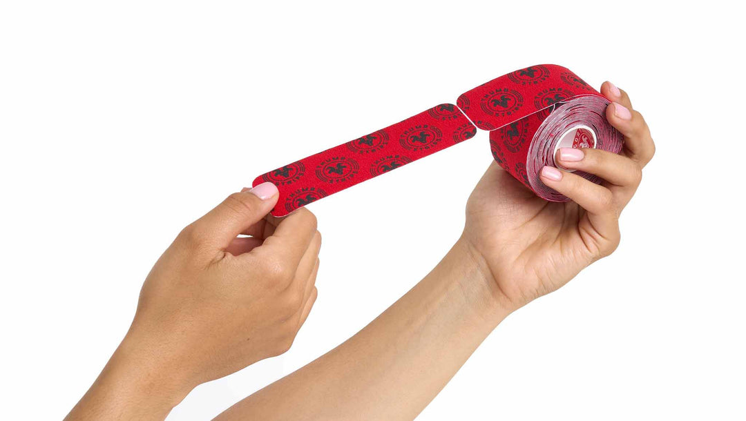 hands holding a red thumbs tape with black logo
